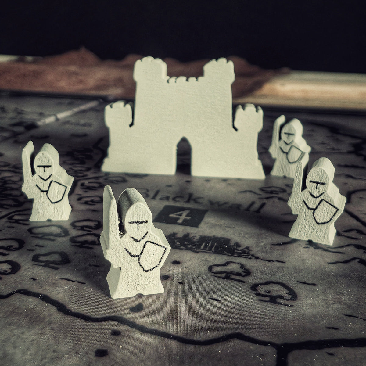 Inquisitor Meeples in front of the fortress token in the cult strategy deckbuilding board game Eschaton: Iconoclasm.