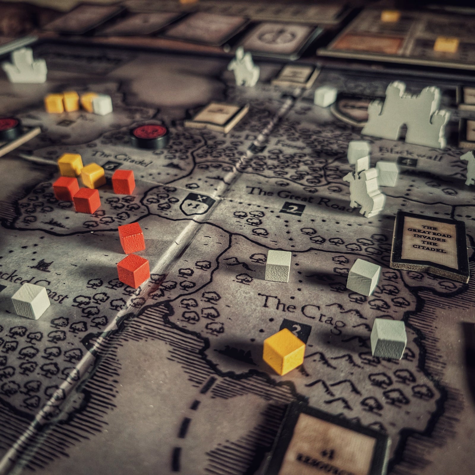 Inquisitor forces dominate half the realm in Eschaton: Iconoclasm. Detail view of board game tokens on the game board.