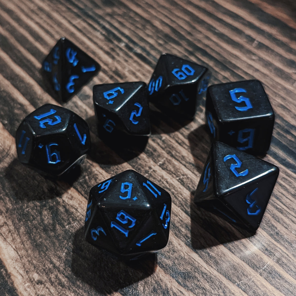 Black and Blue DND dice set. High-contrast dark fantasy polyhedral RPG dice.