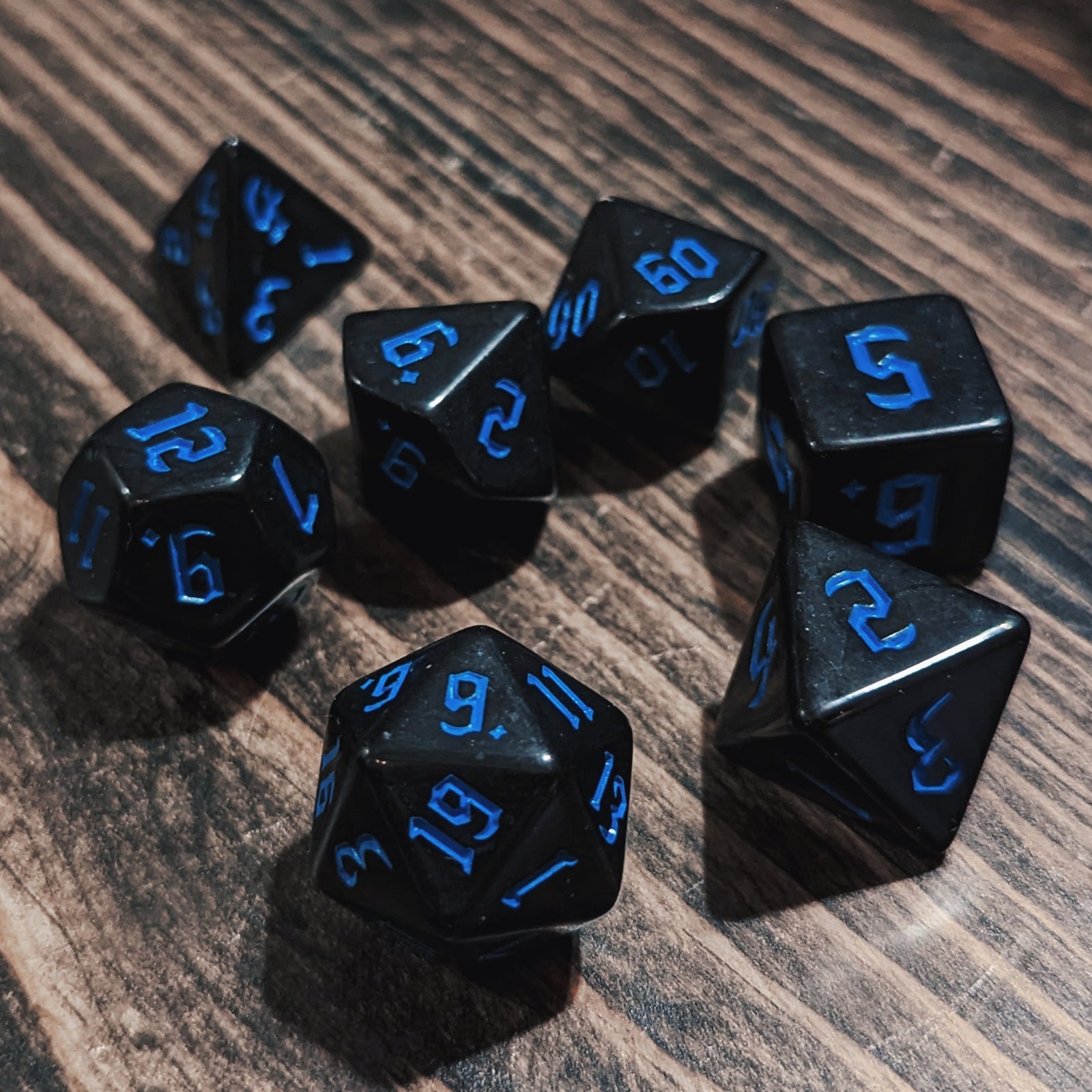 Black and Blue DND dice set. High-contrast dark fantasy polyhedral RPG dice.