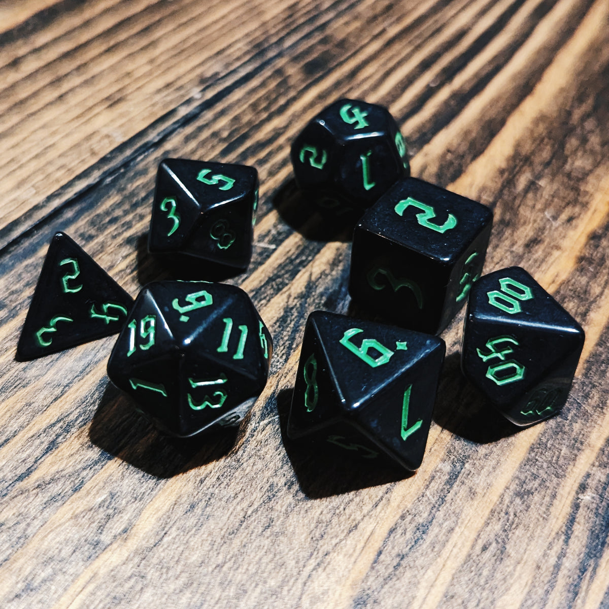 Black and Green DND dice set. High-contrast dark fantasy polyhedral RPG dice.
