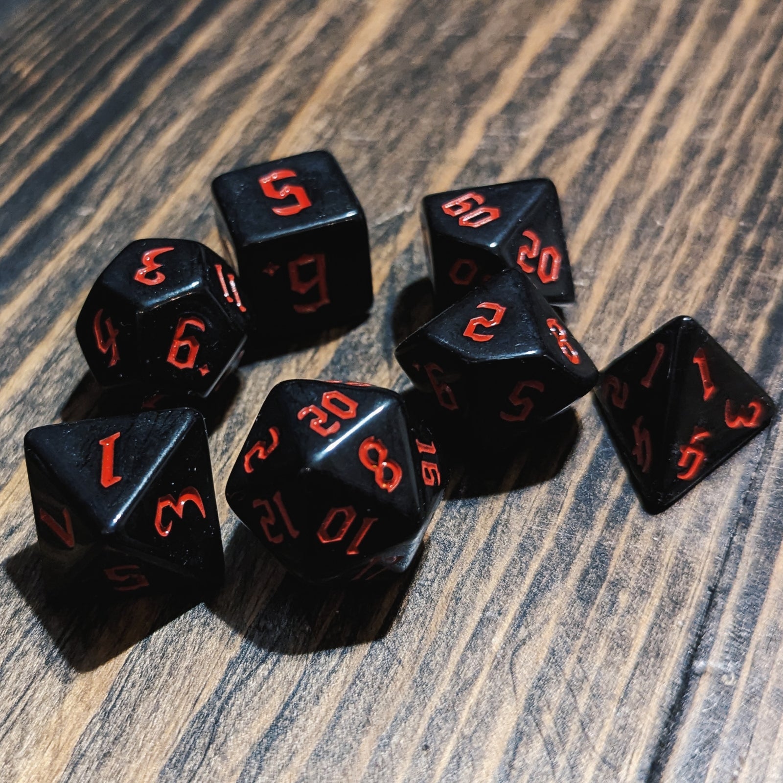 Black and Red DND dice set.High-contrast dark fantasy polyhedral RPG dice.