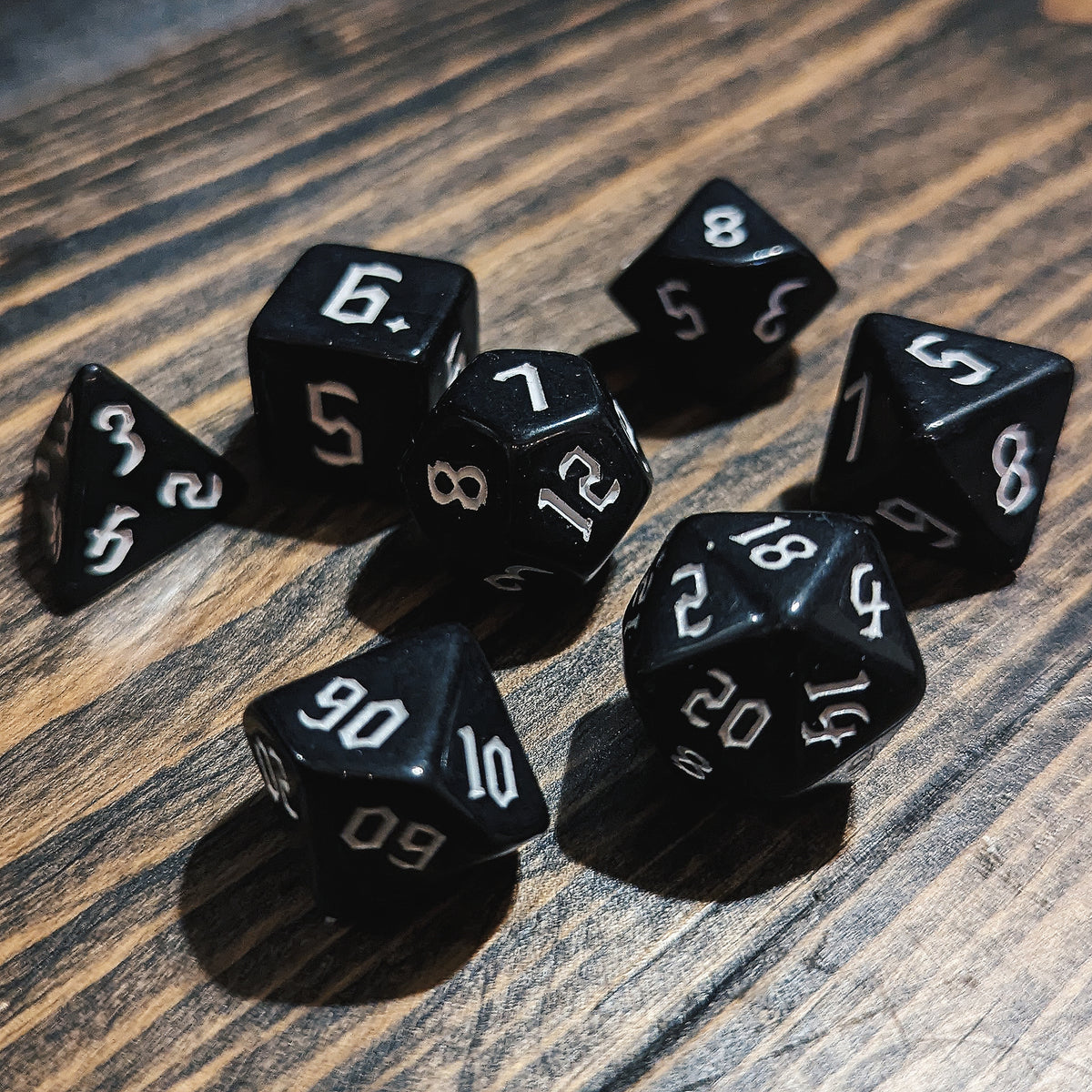 Black and White DND dice set. High-contrast dark fantasy polyhedral RPG dice.