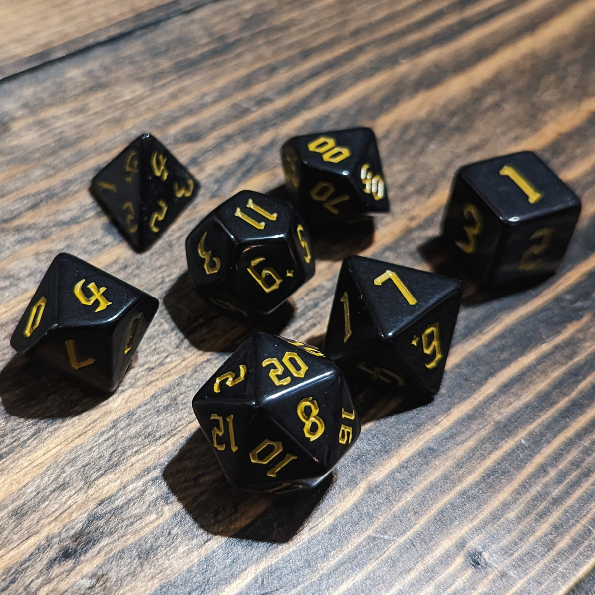 Black and Yellow DND dice set. High-contrast dark fantasy polyhedral RPG dice.
