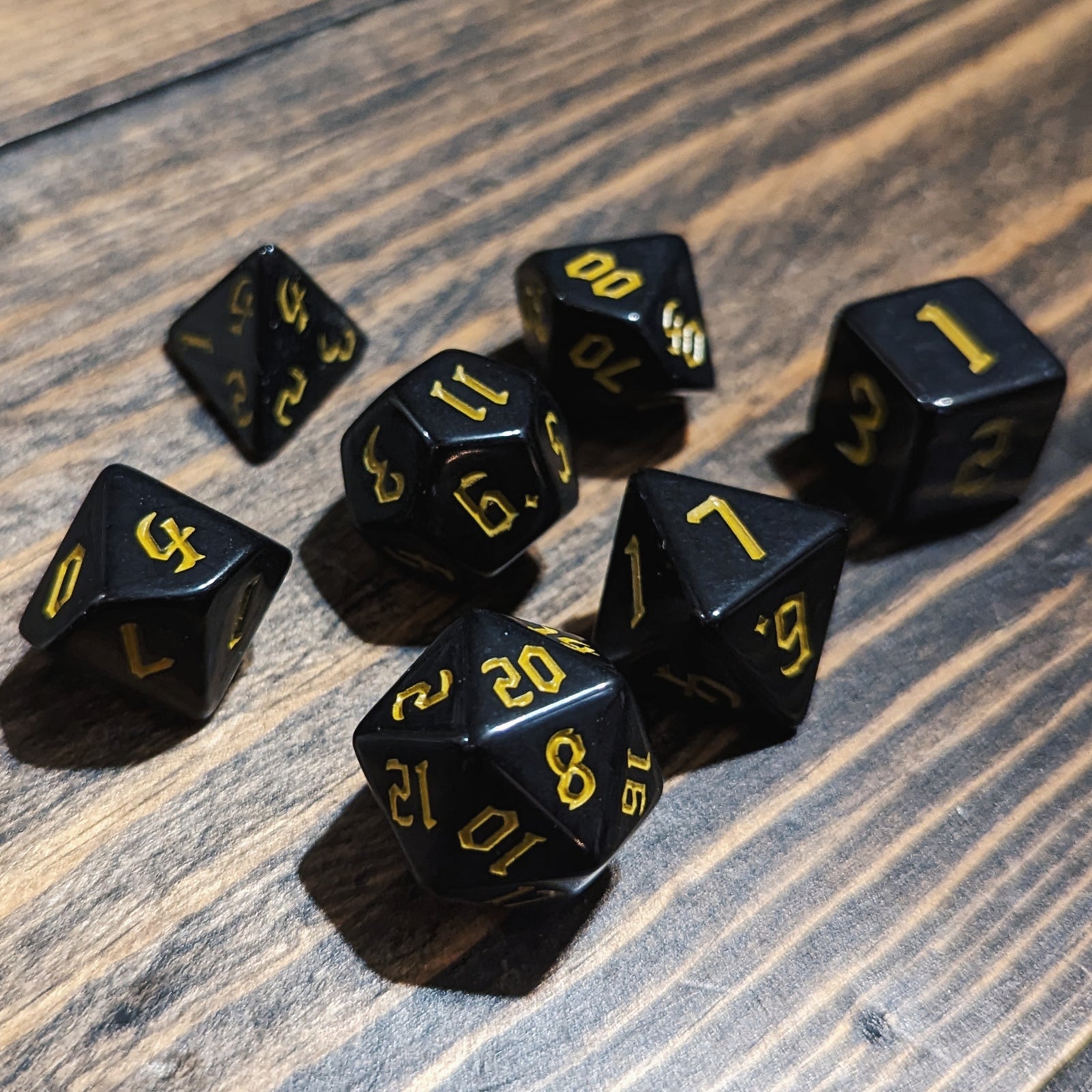 Black and Yellow DND dice set. High-contrast dark fantasy polyhedral RPG dice.